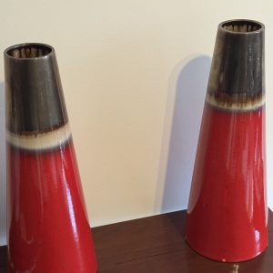 A pair of volcanic red Doulton vases